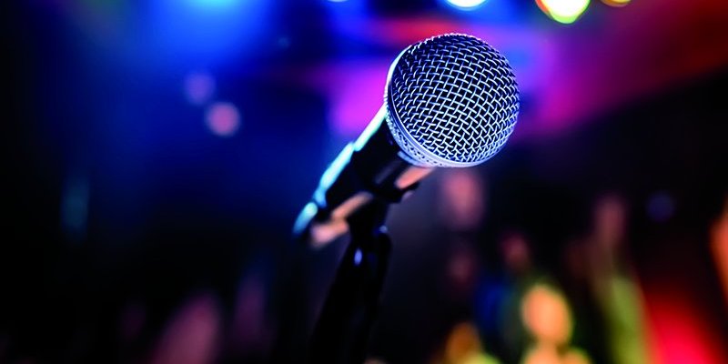 Microphone on stage against a background of auditorium.